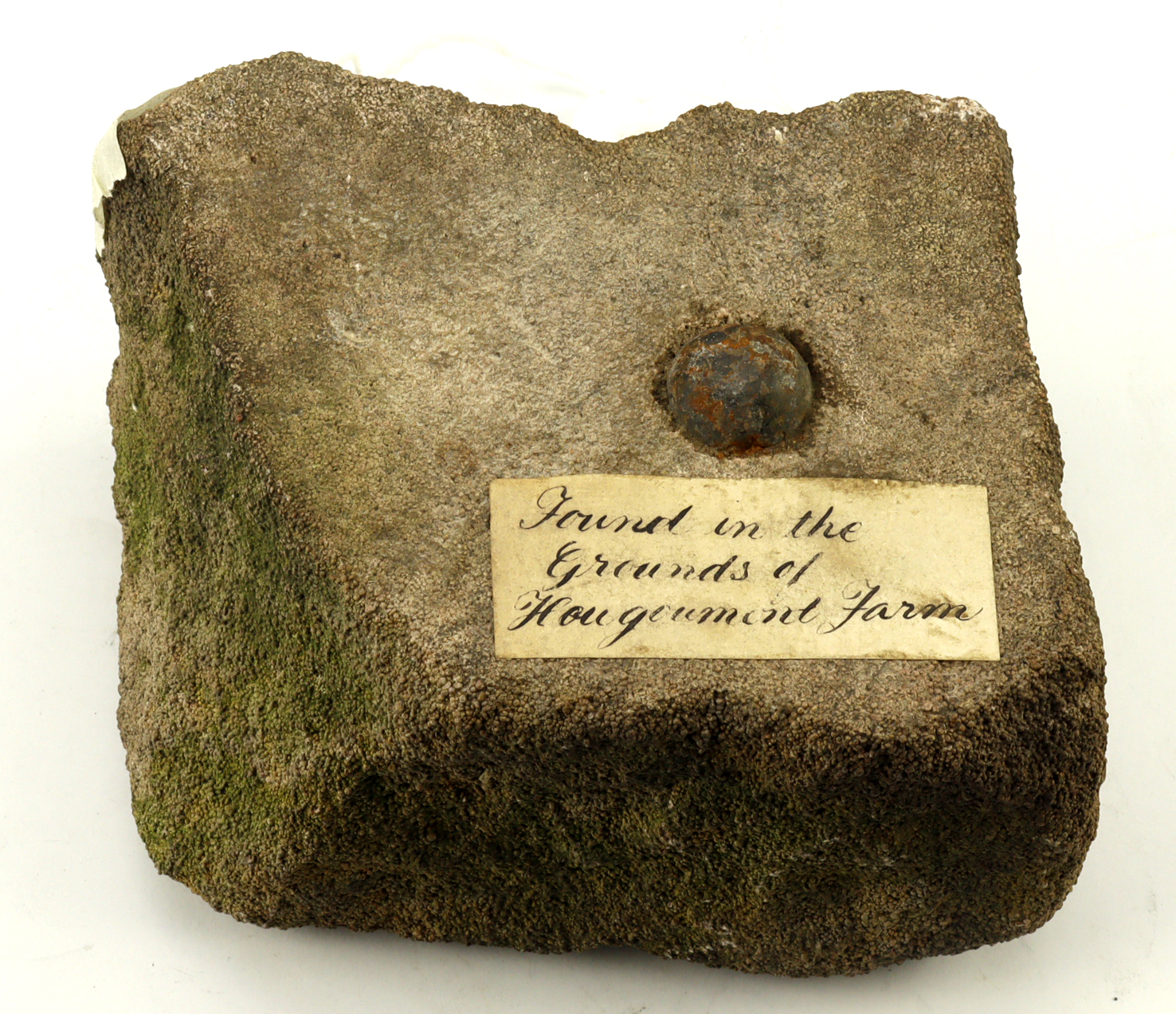 A musket ball embedded in a piece of a wall