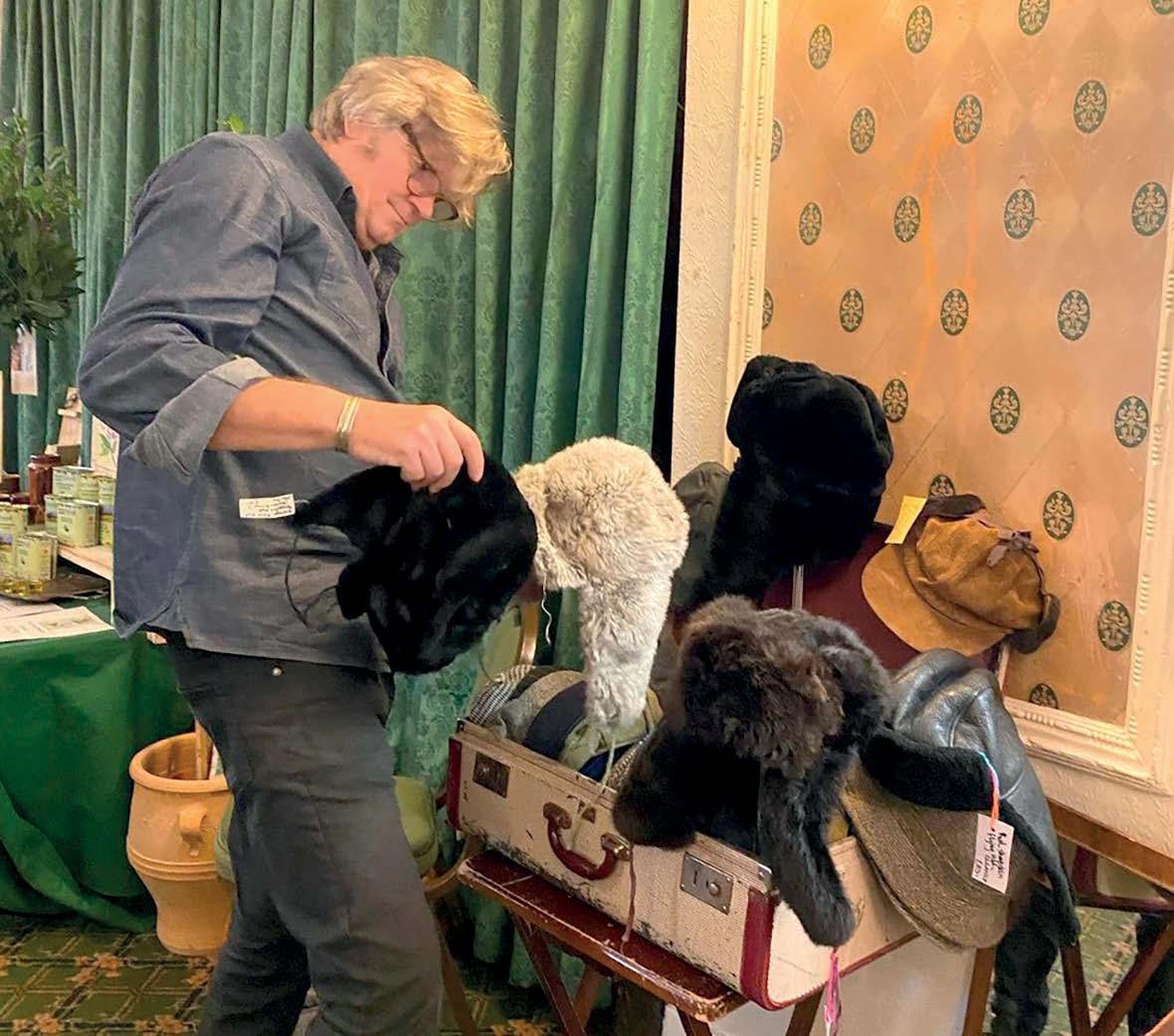 A customer looking at hats at a fashion fair
