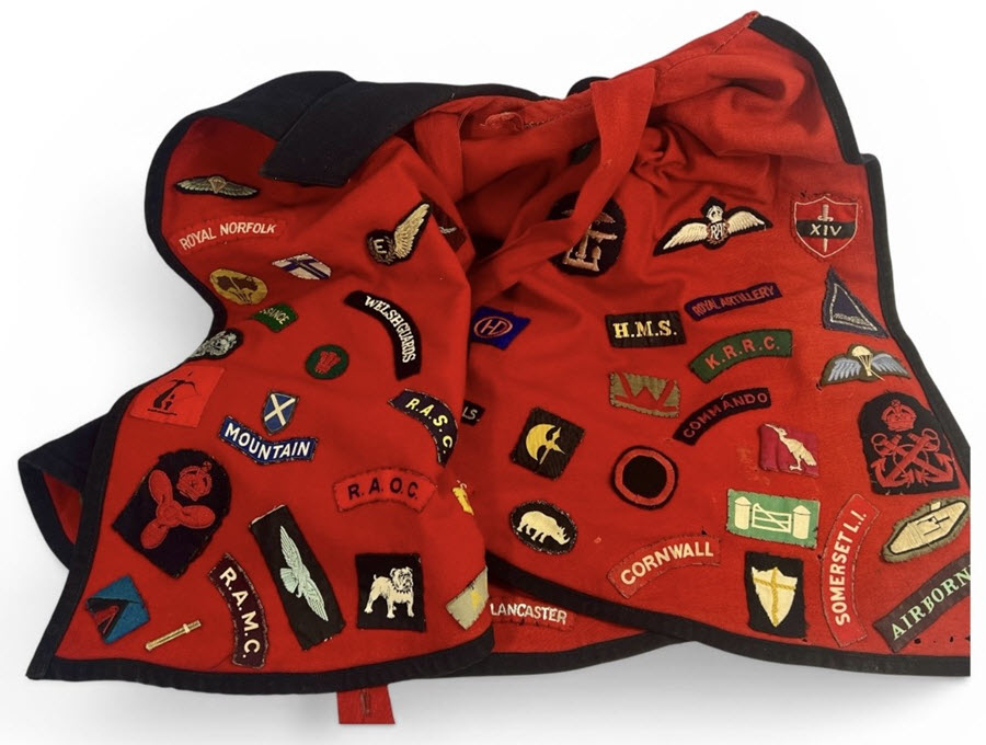 Edwardian nurse’s cape adorned with cloth badges 