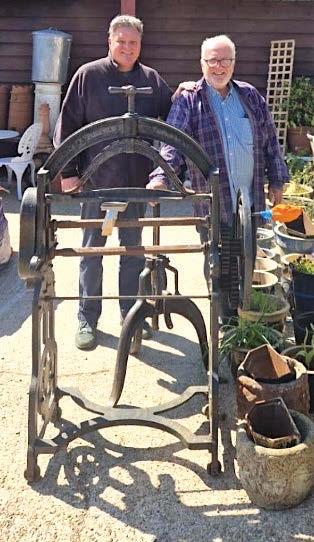 Two antiques dealers standing outside their warehouse