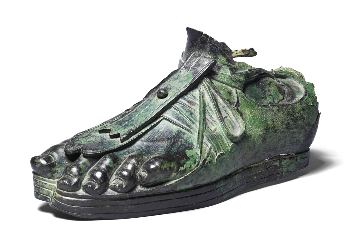 Bronze sandalled foot