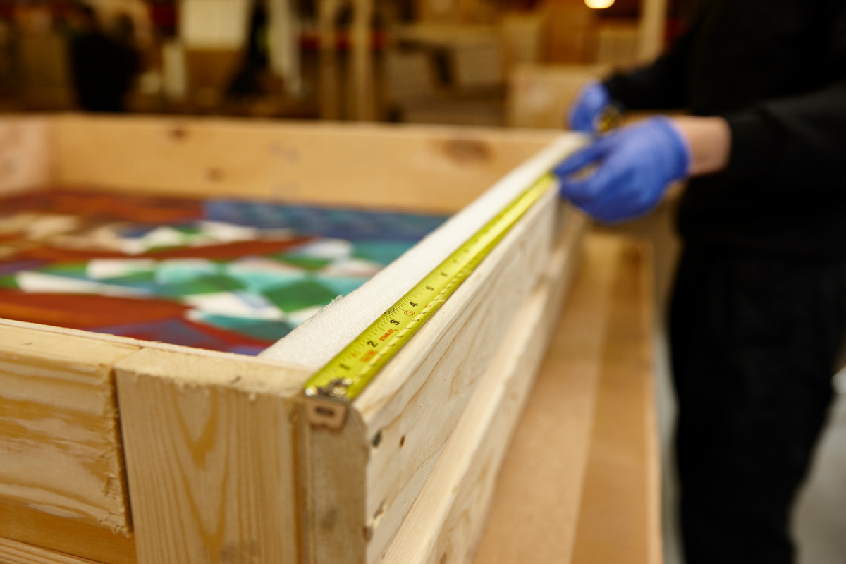 Measuring a painting ready for shipping.